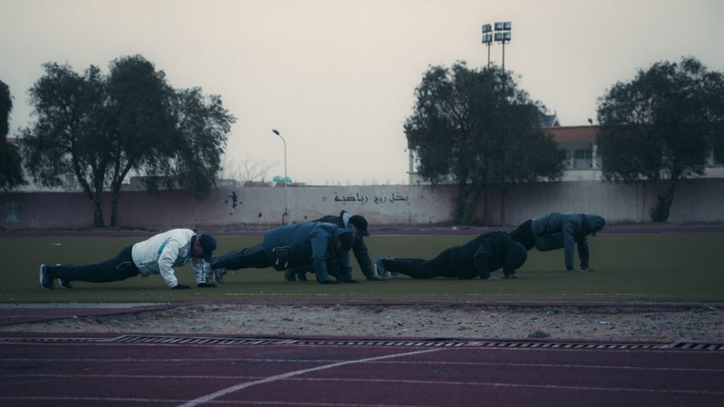 a group of people on a track doing push ups